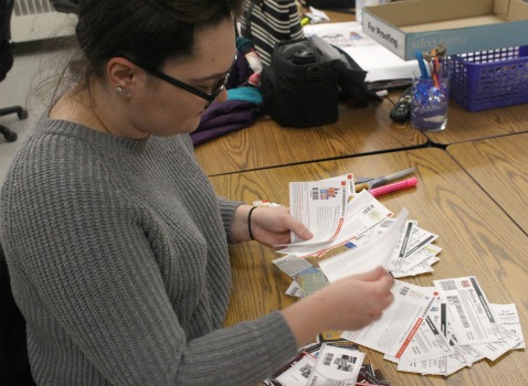 Ciara Diana, a Graphic Design student sorts through a stack of coupons during her free time from class. PHOTO BY HALEY SEDGWICK
